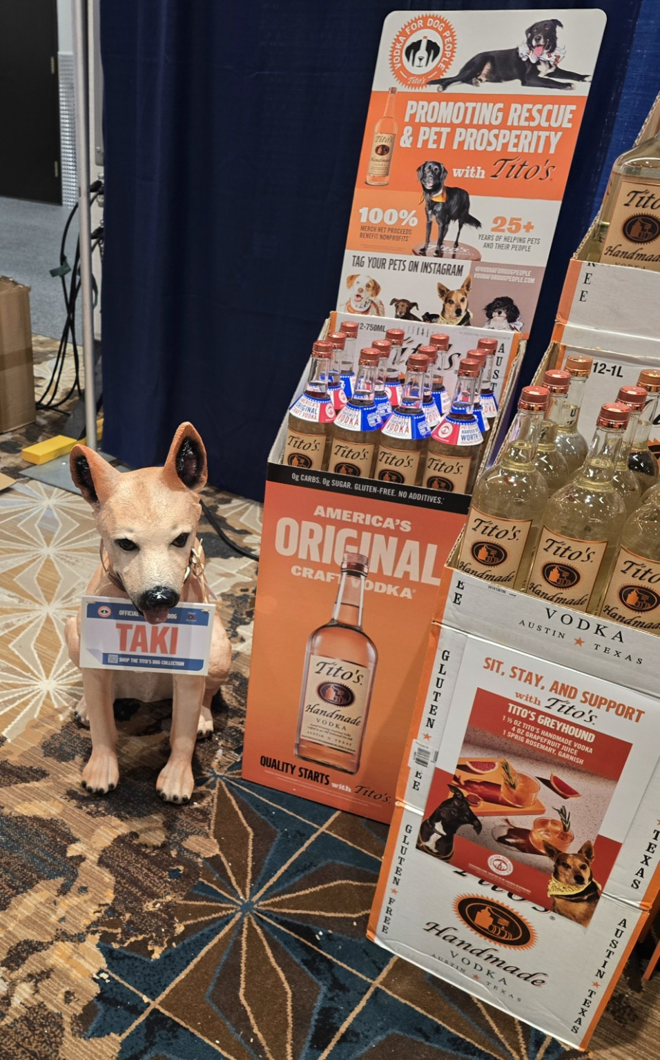 Tito’s vodka bottles displayed beside a dog figure.