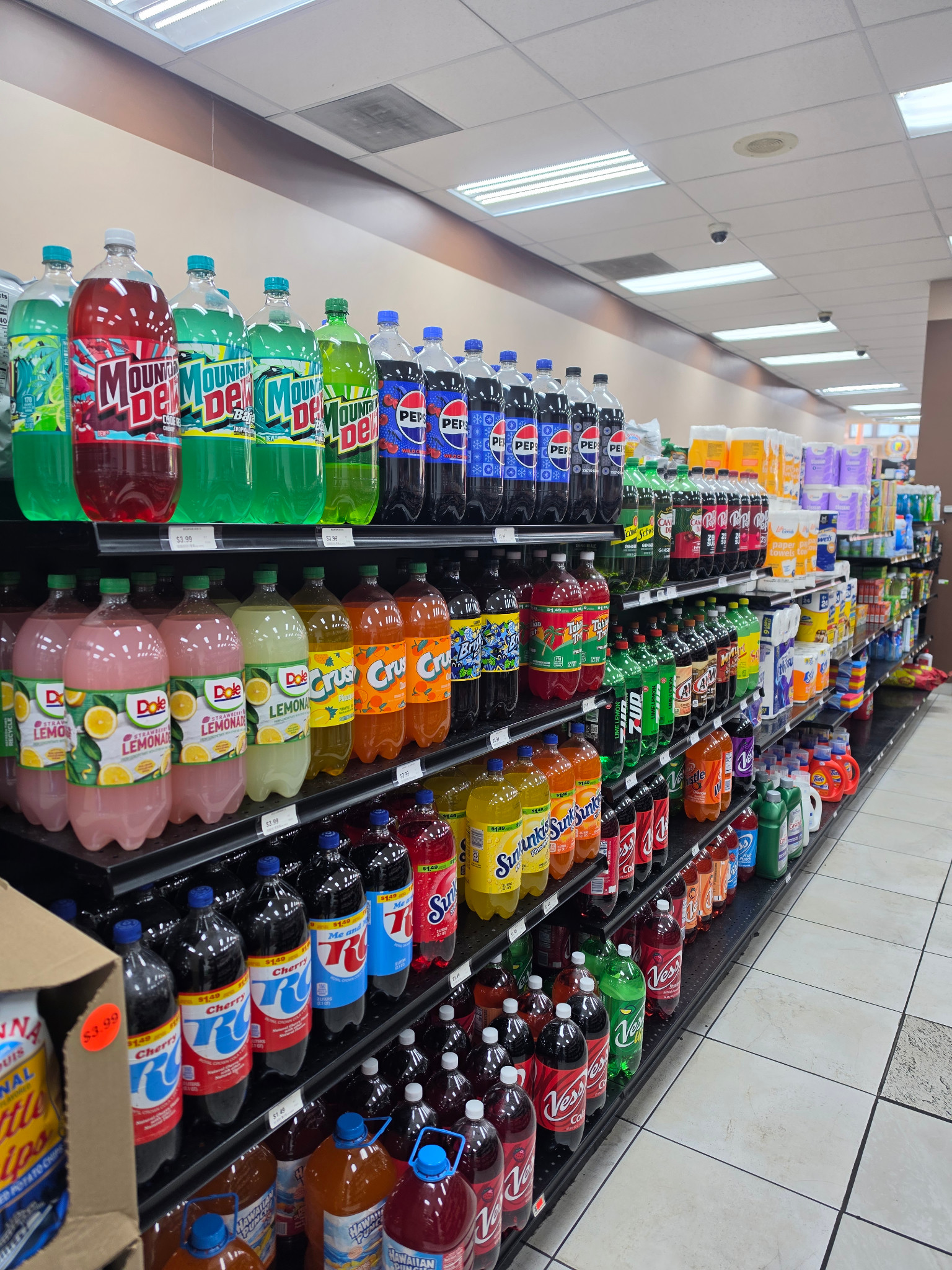 Shelves of soft drinks and household essentials inside James Henry Provisions Co.